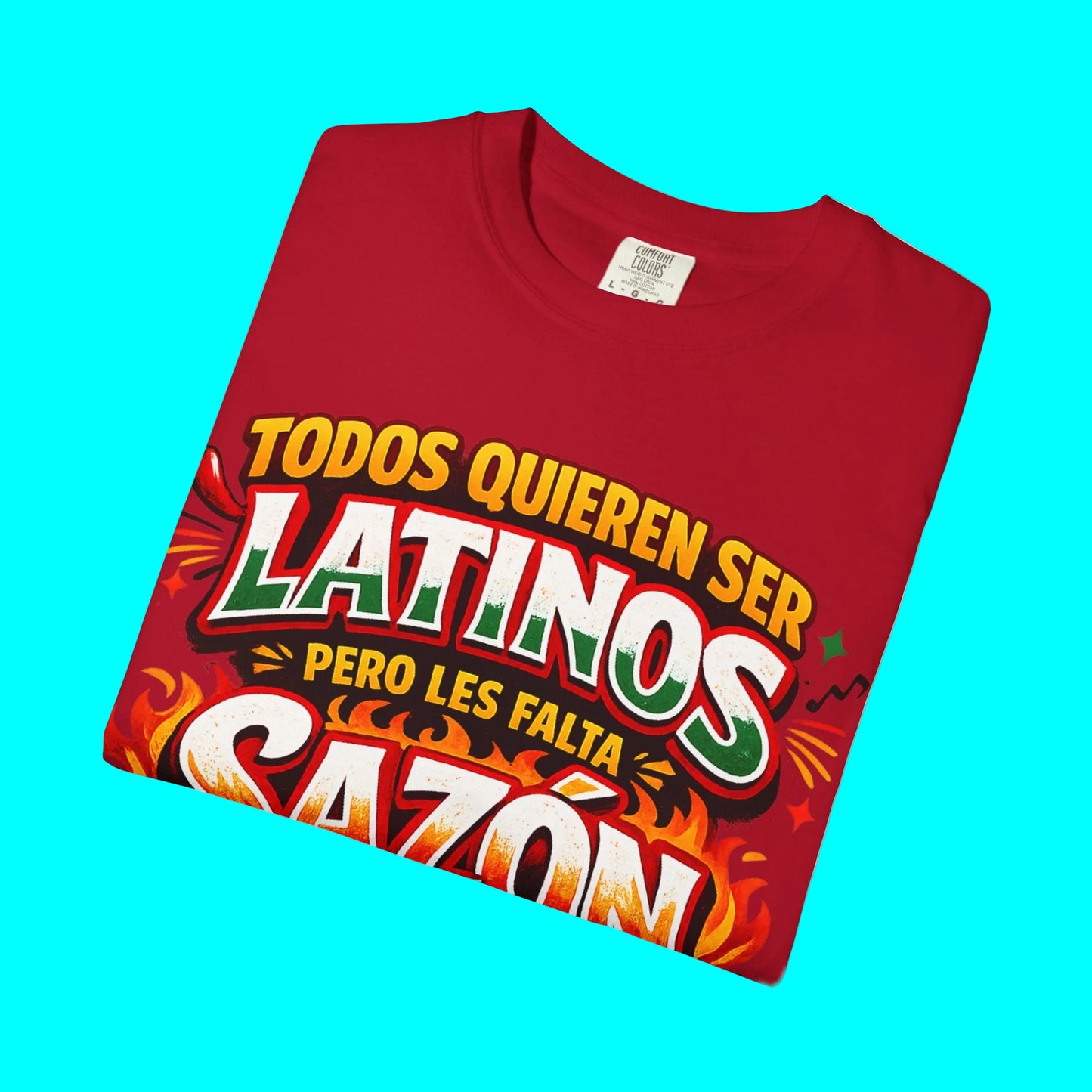 Folded red t-shirt with colorful text design on a white background