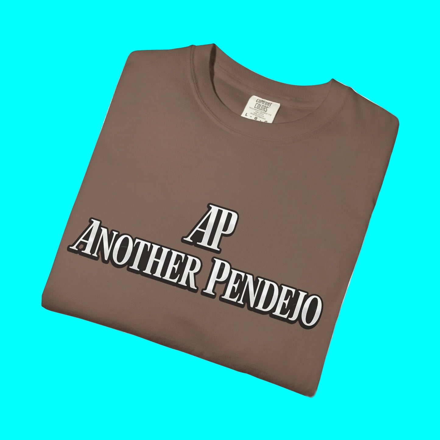 Folded brown t-shirt with 'AP Another Pendeko' text on a white background