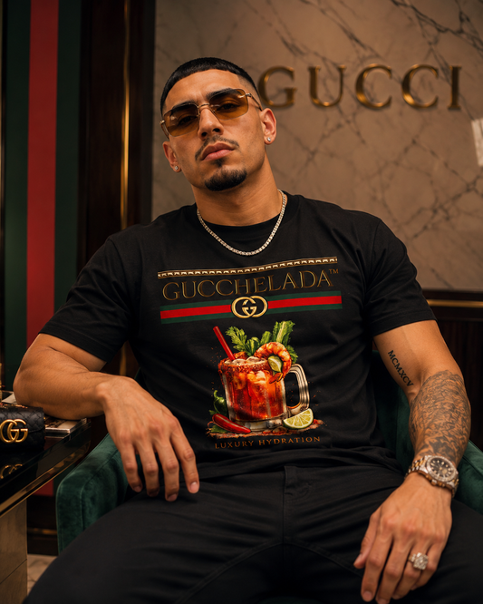 Man wearing a black Gucci t-shirt with a drink graphic in a Gucci-themed room.