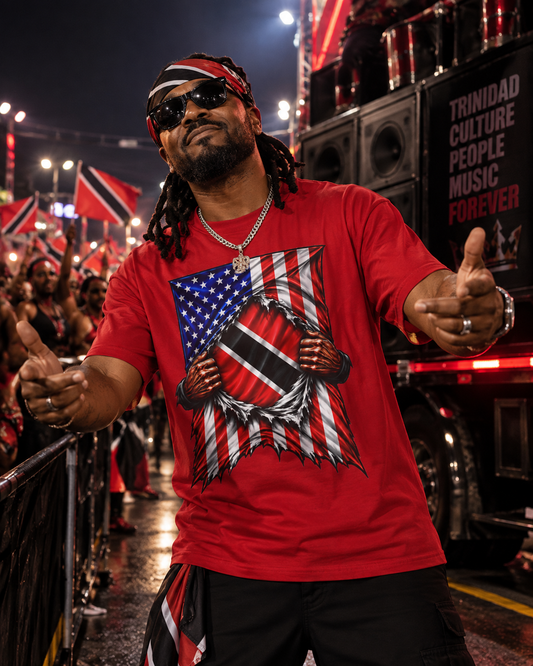 A man wearing a red graphic t-shirt with a stylized Trinidad flag design, black pants, and a Trinidad flag headband, standing in front of a parade crowd at night.