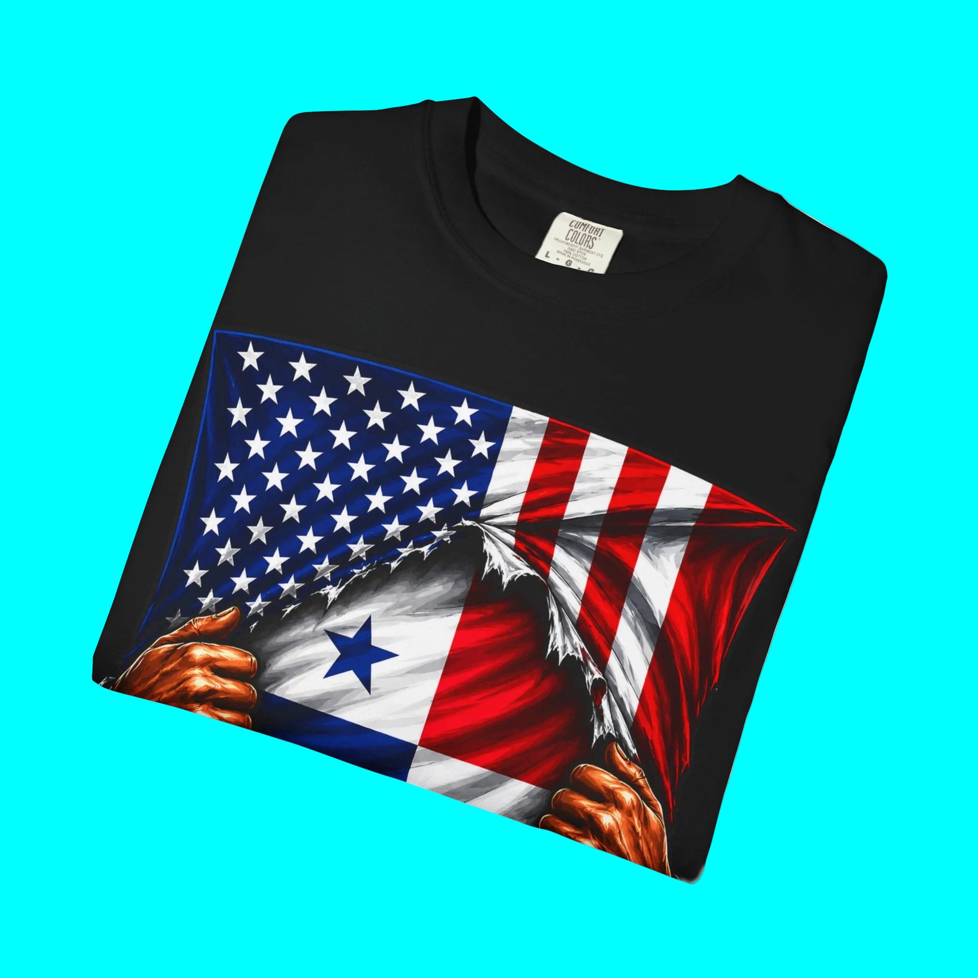 A folded black t-shirt featuring a graphic print of the United States flag being ripped open to reveal the flag of Panama underneath, with two muscular hands tearing the fabric. The shirt is displayed on a clean white background.