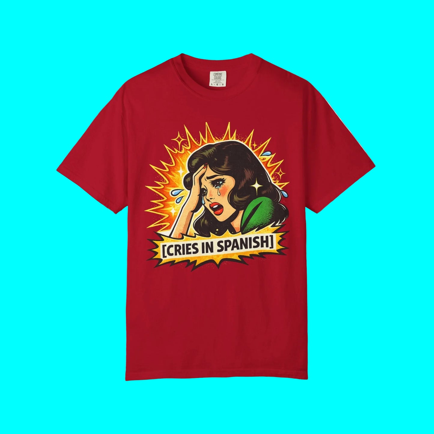 Red t-shirt with graphic design of a woman crying and text 'Cries in Spanish' on a white background