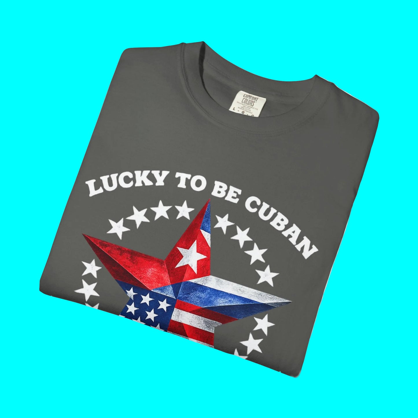 Folded gray t-shirt with 'Lucky to be Cuban' design featuring a star and stars on a white background.