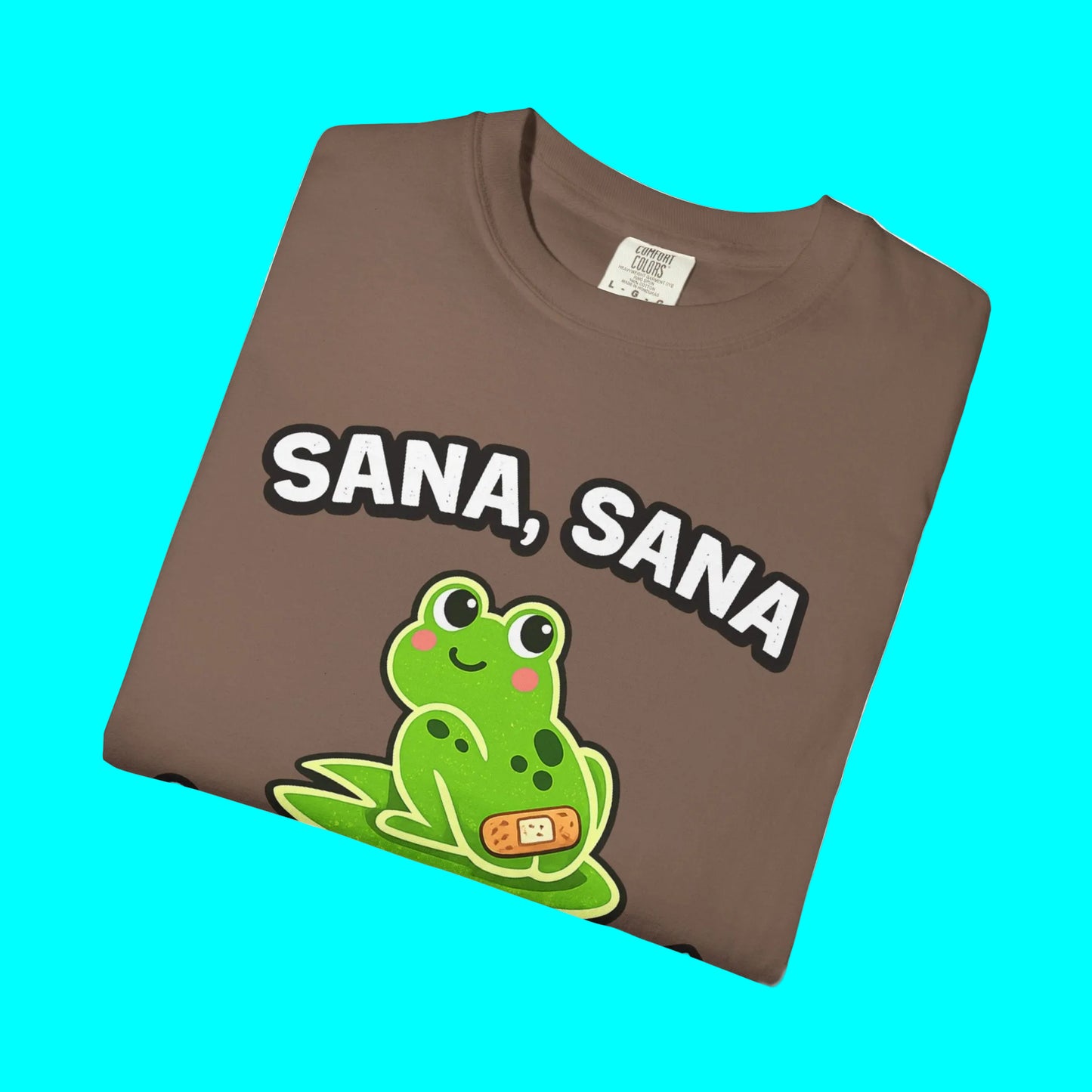 Brown t-shirt with a green frog graphic and 'SANA, SANA' text on a white background