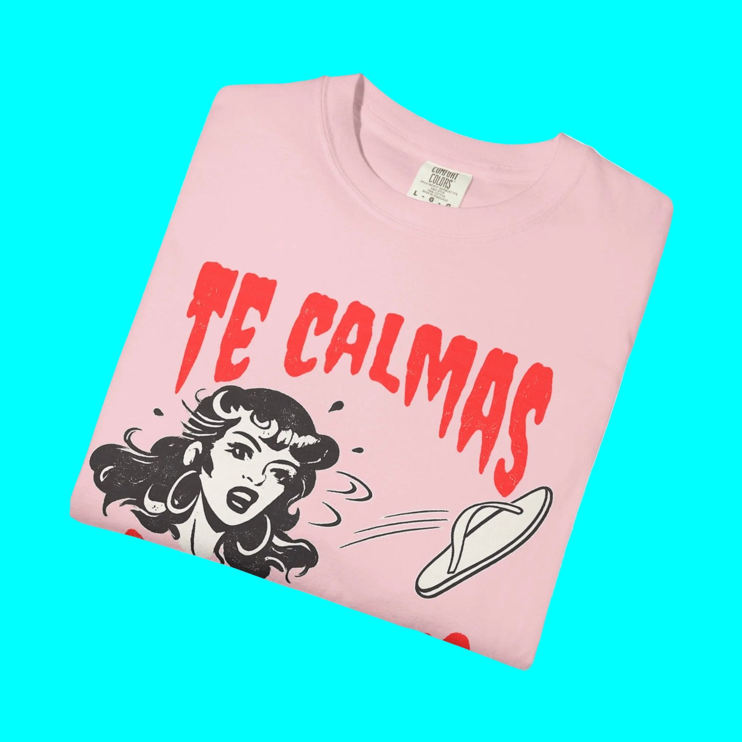 Folded pink t-shirt with graphic design and text on a white background