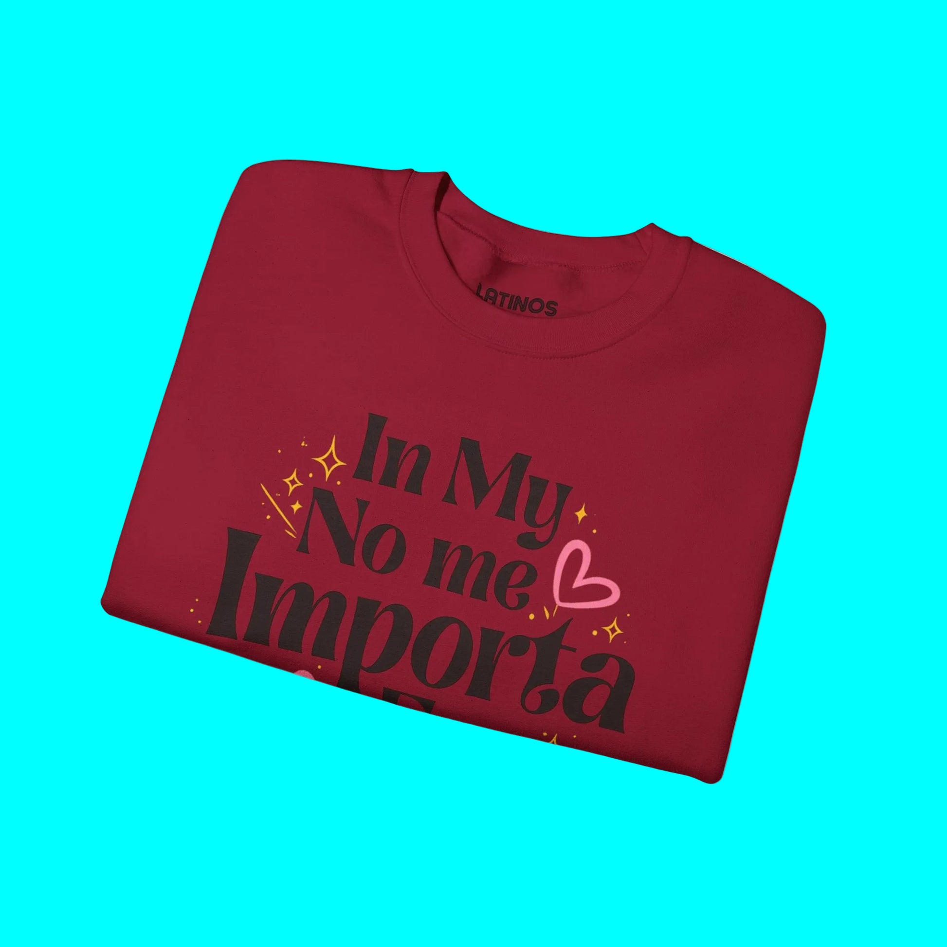 Folded red t-shirt with text 'In My No me Importa' on a white background