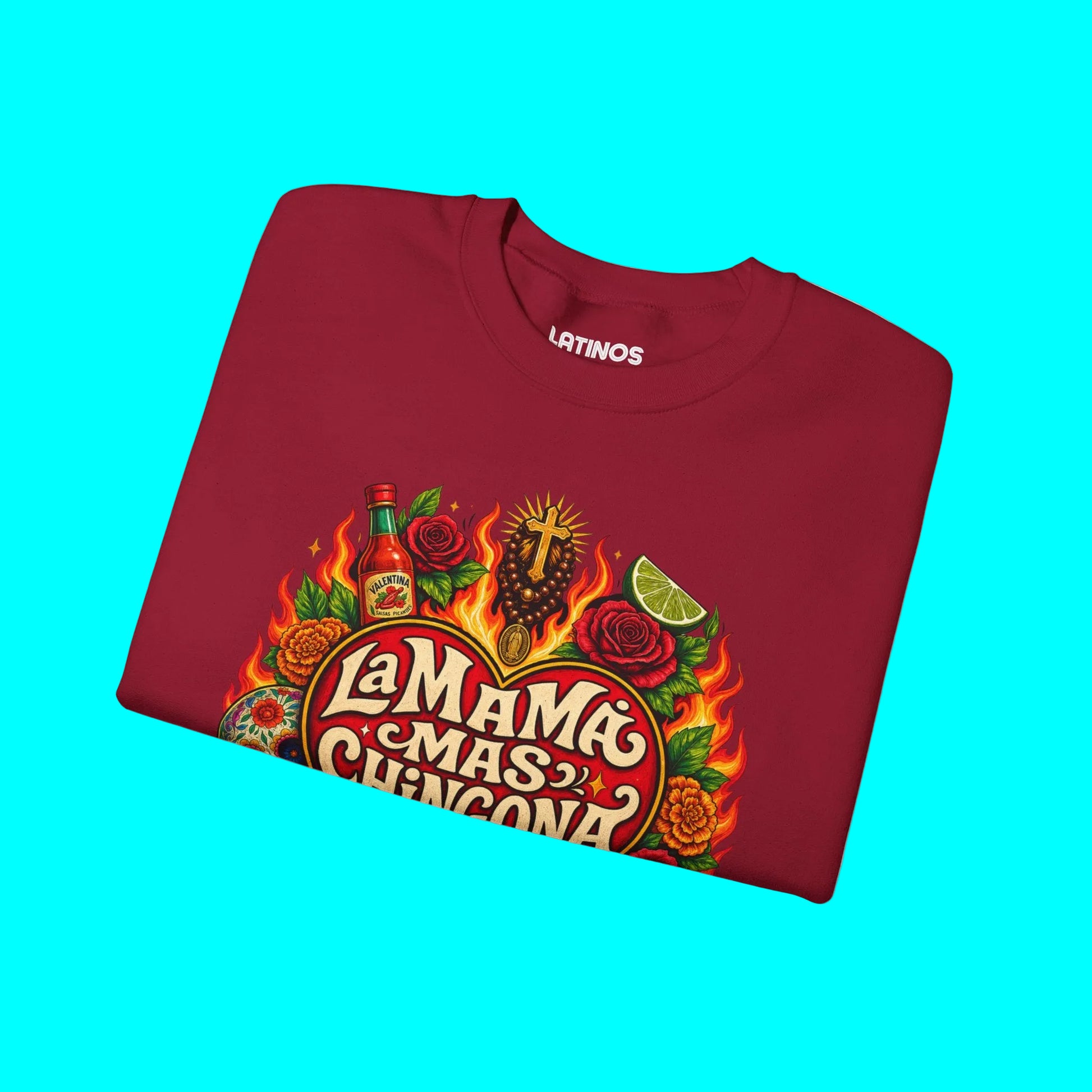 Folded maroon sweatshirt with colorful graphic design on a white background