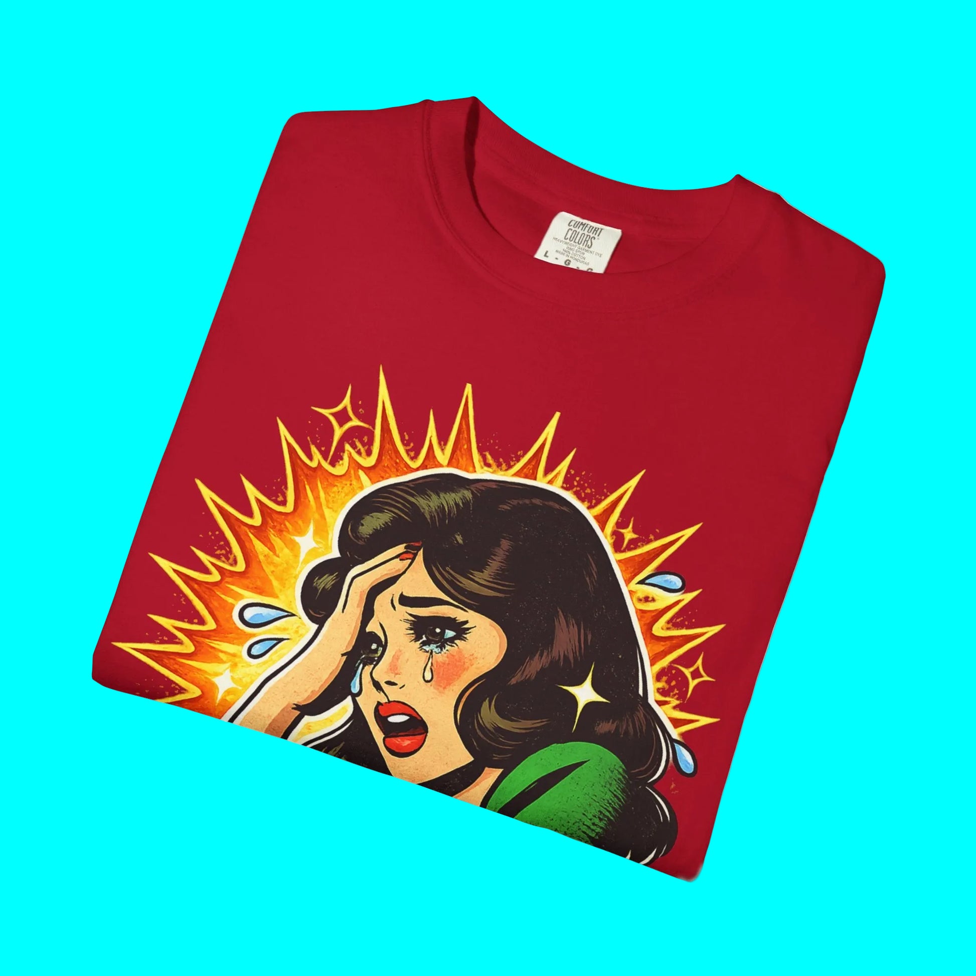 Folded red t-shirt with a graphic of a woman with a shocked expression on a white background