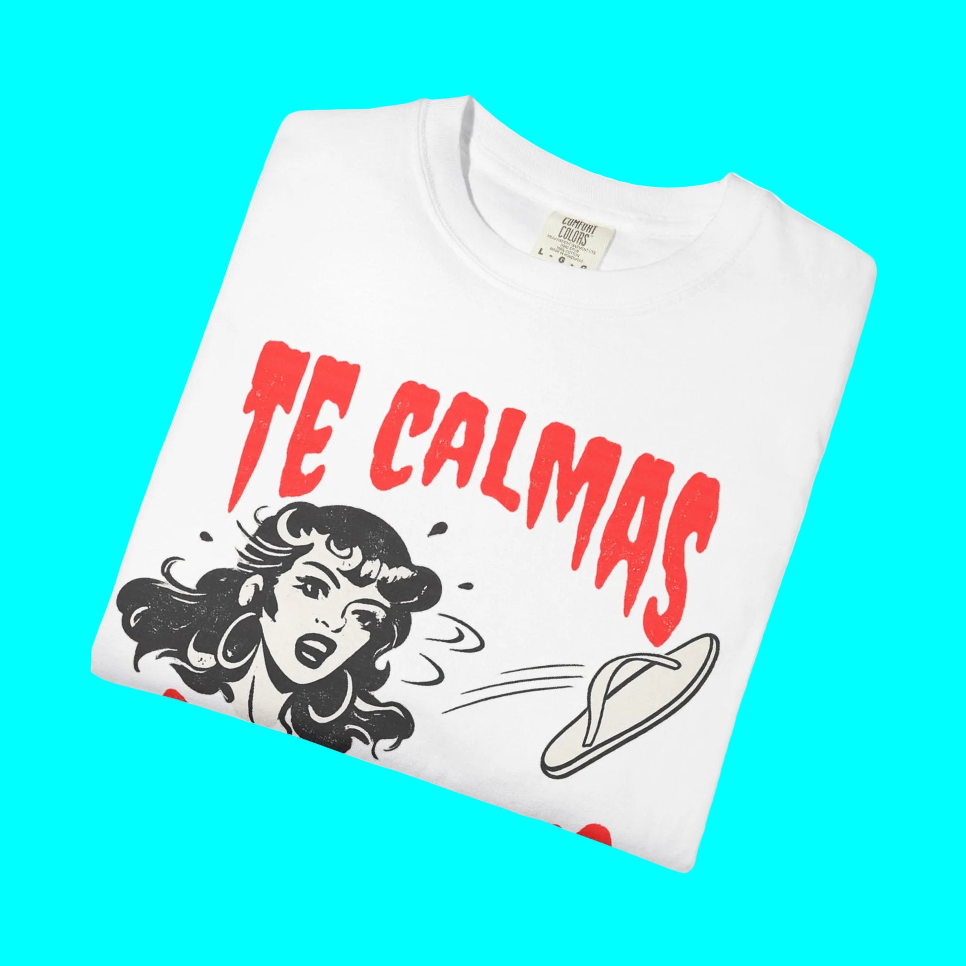 White t-shirt with red text 'TE CALMAS' and graphic design on a white background