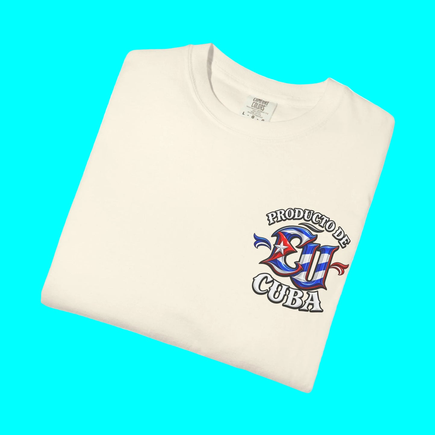 A folded cream-colored t-shirt with a colorful graphic on the left chest that reads 'PRODUCTIVE CUBA' with a stylized 'CU' emblem in red, white, and blue, set against a plain white background.