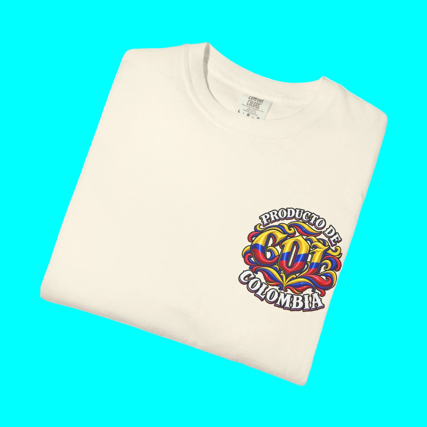 A folded cream-colored t-shirt with a colorful graphic on the left chest that reads 'PRODUCTO DE BOZO COLOMBIA' in a graffiti-style design with red, yellow, and blue colors, set against a plain white background.