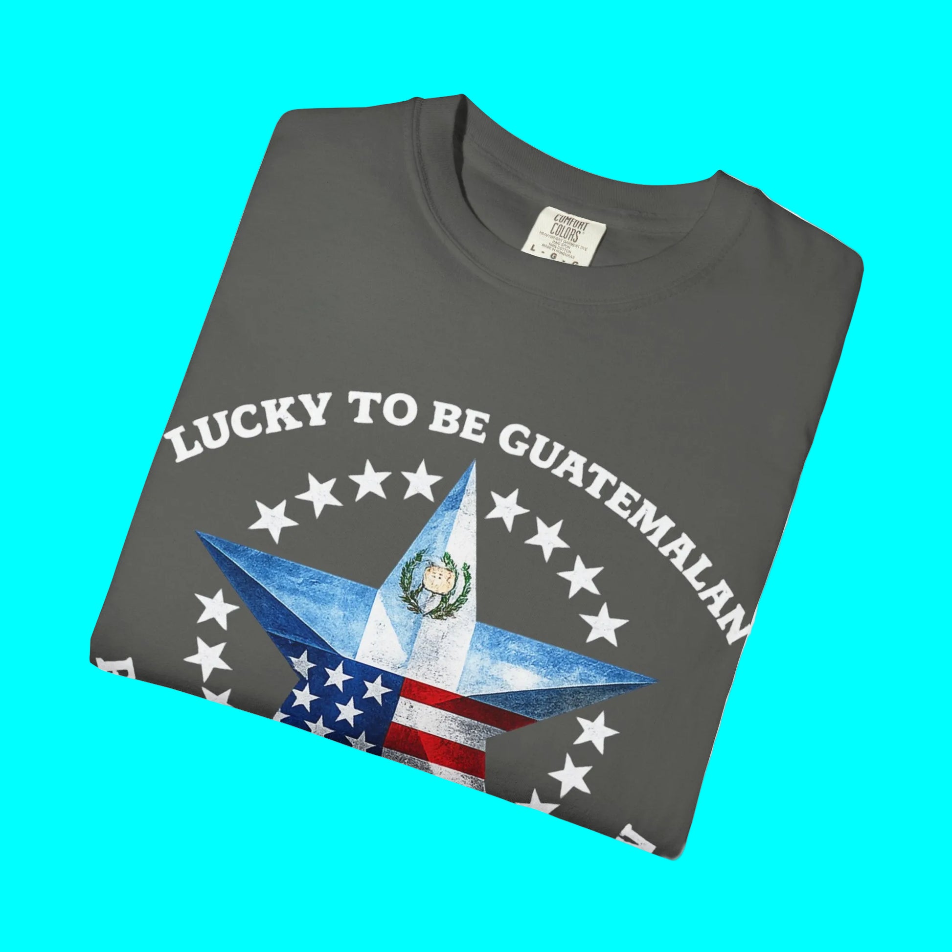 Gray t-shirt with 'Lucky to be Guatemalan' text and star design on a white background