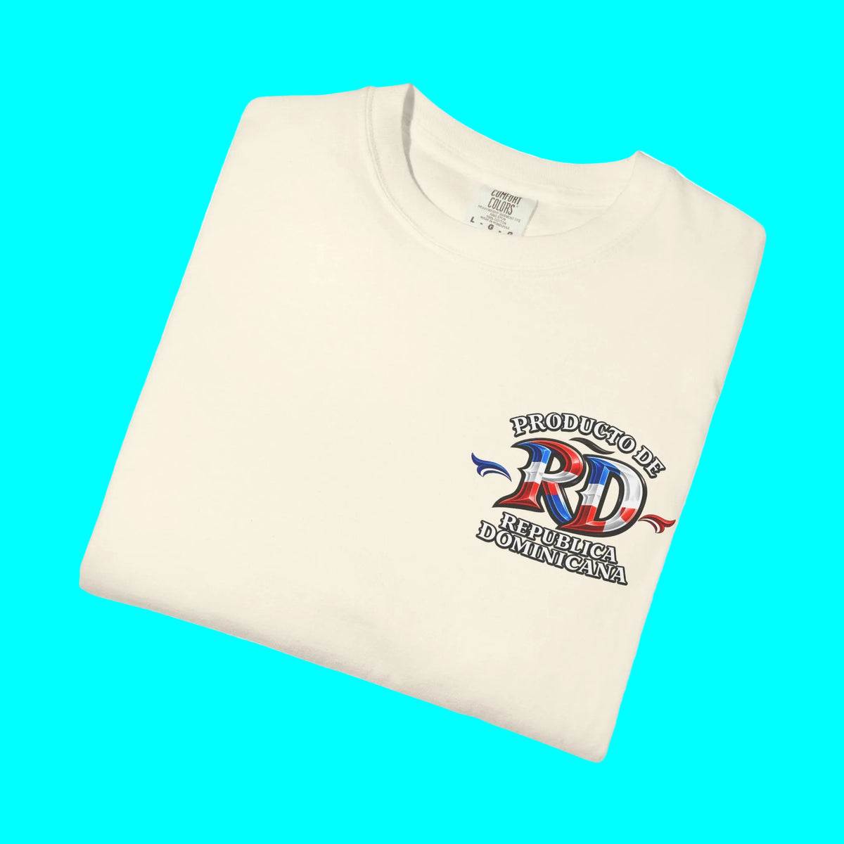 A folded cream-colored t-shirt with a graphic on the left chest that reads 'PRODUCTO DE REPUBLICA DOMINICANA' around a stylized 'RD' filled with the Dominican flag colors, set against a plain white background.