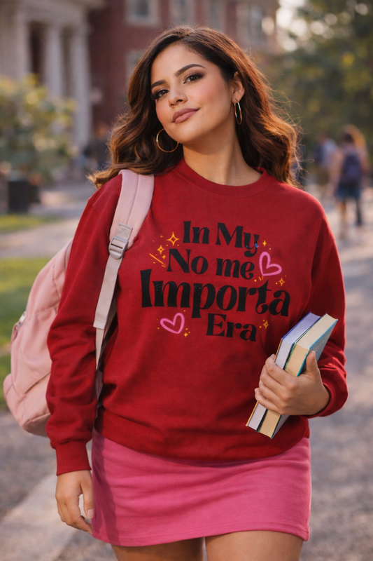 Woman wearing a red sweatshirt with text, holding books, and walking outdoors.