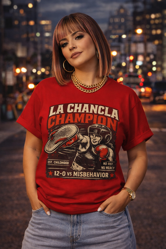Woman wearing a red t-shirt with 'La Chancila Champion' design in an urban night setting.