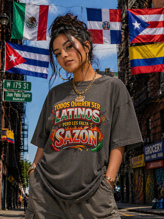 Woman wearing a t-shirt with colorful text in an urban setting with flags in the background