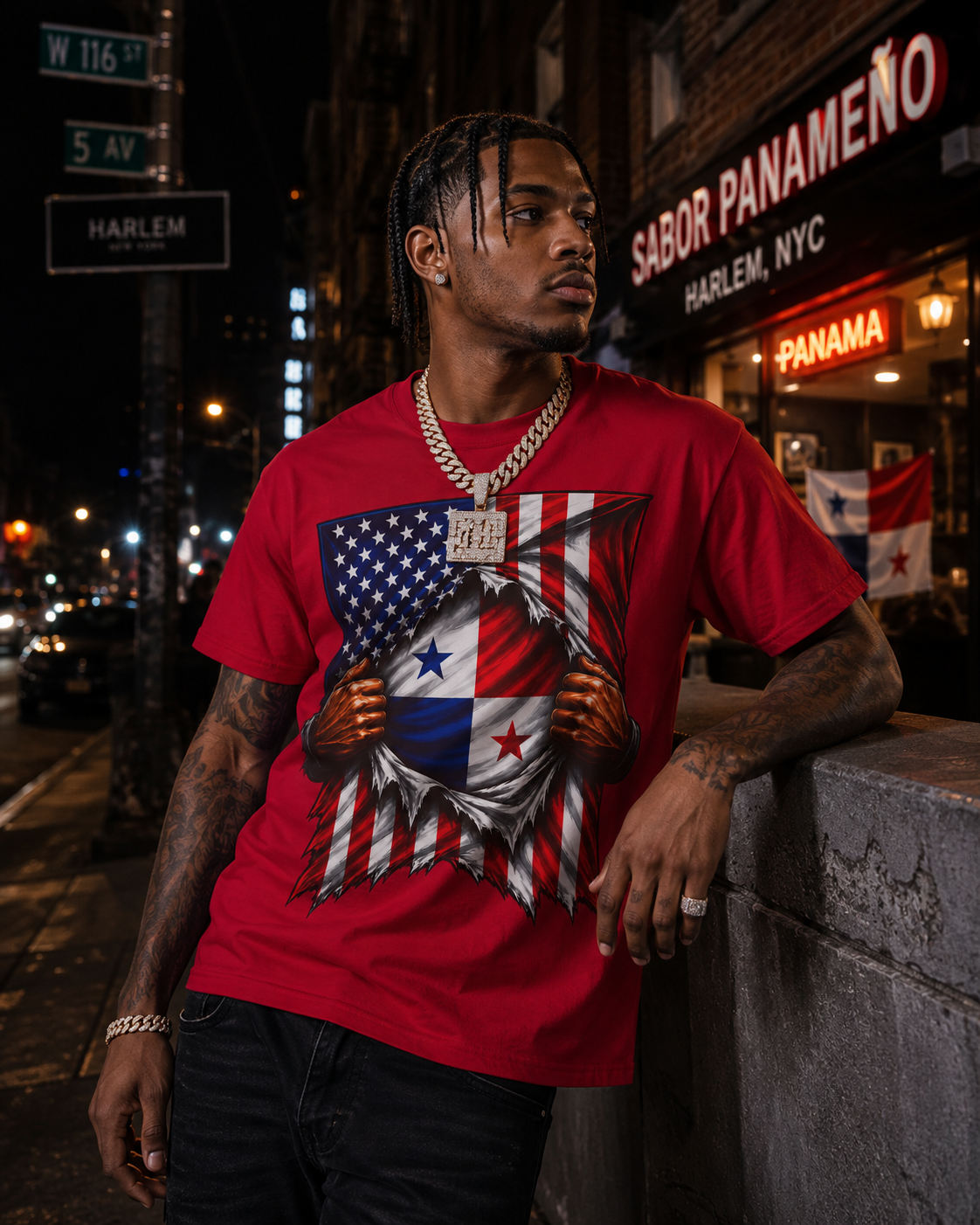 A man wearing a red graphic t-shirt with a patriotic American and Panama flag design, standing on a city street at night.