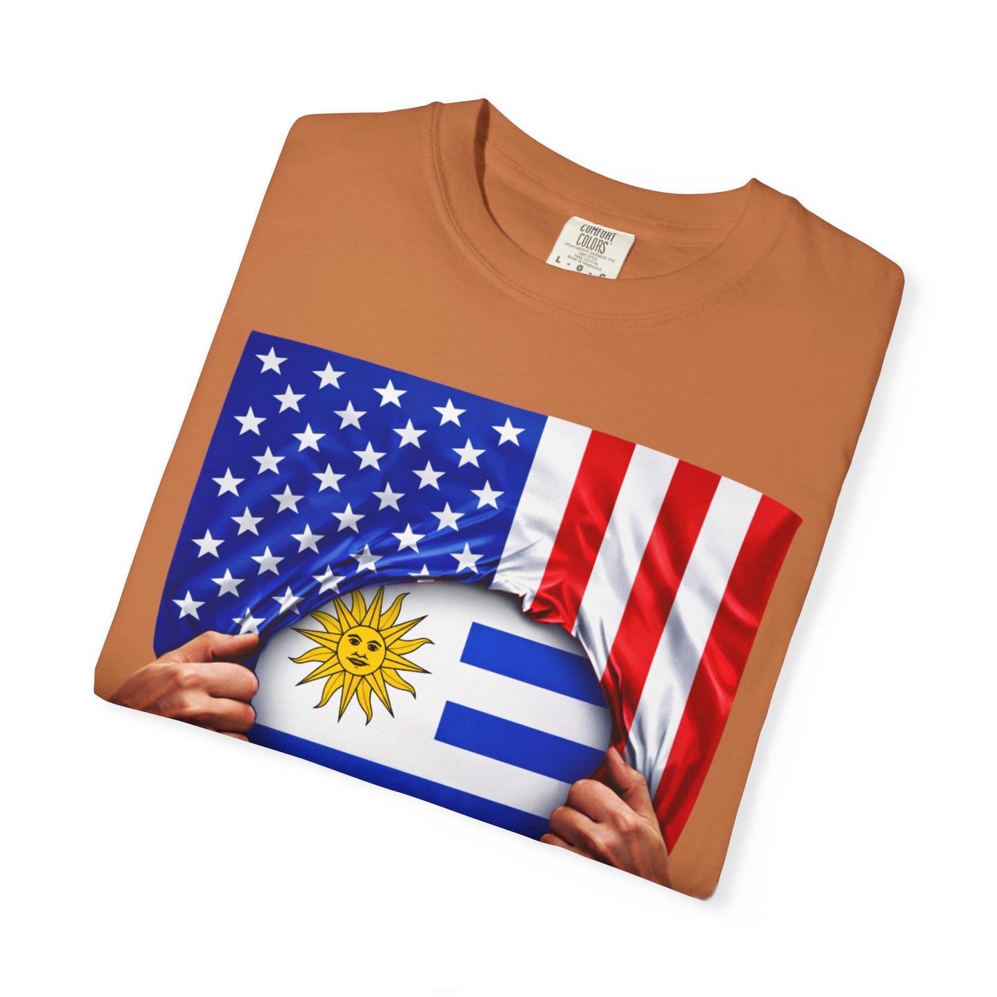 Brown t-shirt with American and Uruguayan flags held by hands on a white background