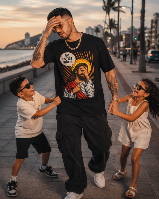 Man in a black t-shirt with a graphic design, standing with two children on a city street.